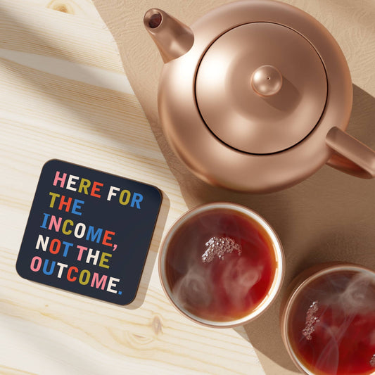 Here for the Income typographic coaster shown propped at an angle to display its glossy MDF finish