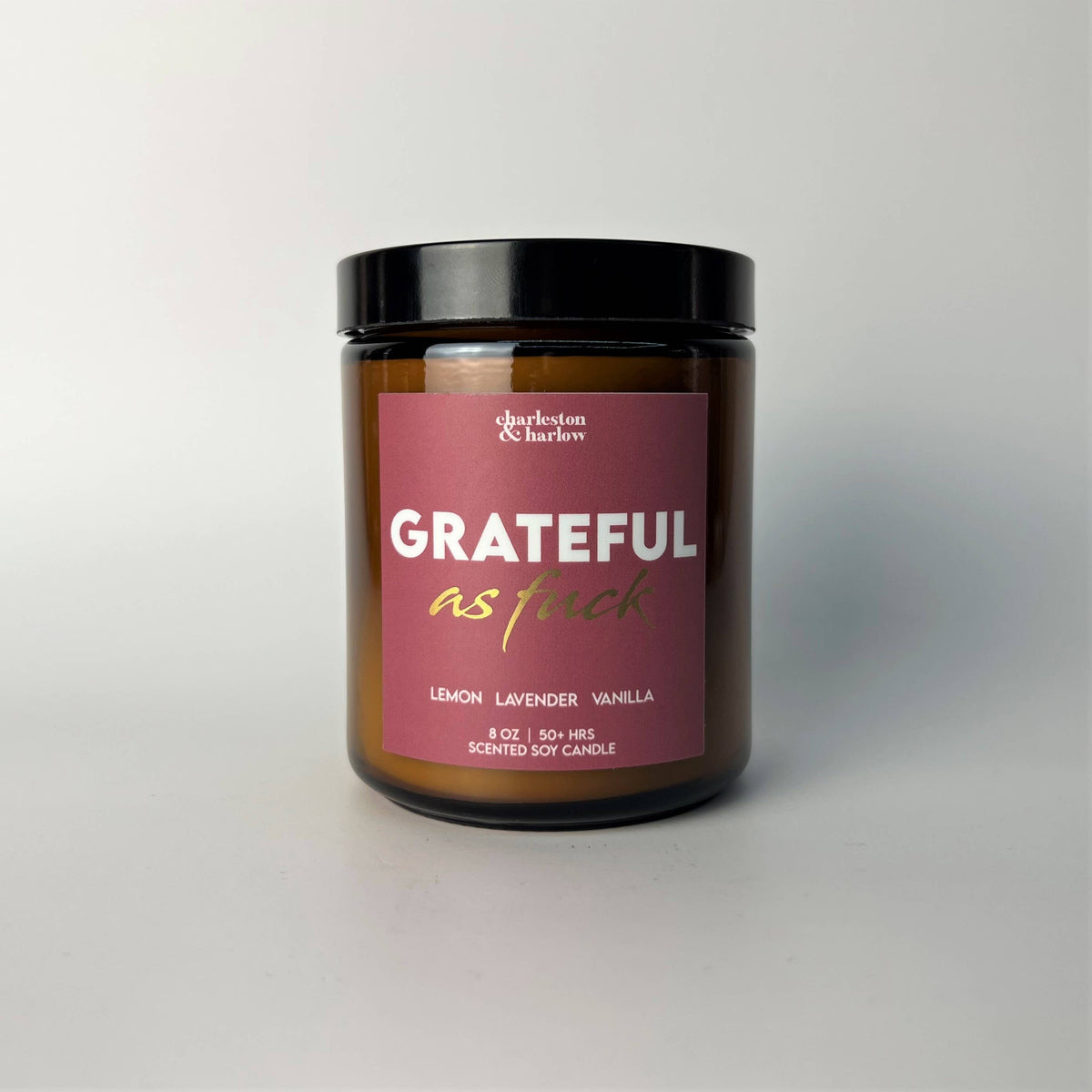 Charleston & Harlow Grateful As Fuck soy candle in amber glass jar with dusty rose label and gold script