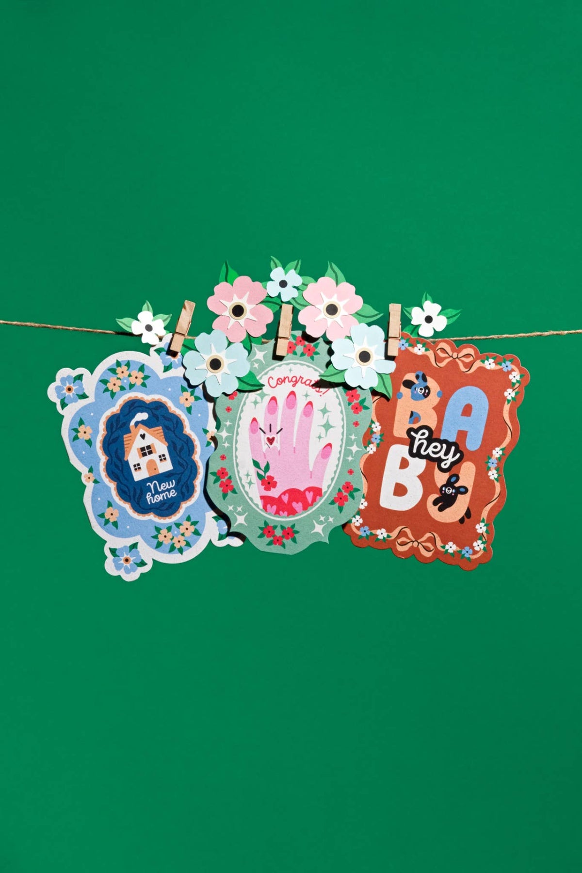 Birthday cake card standing upright showing its oval die-cut shape.