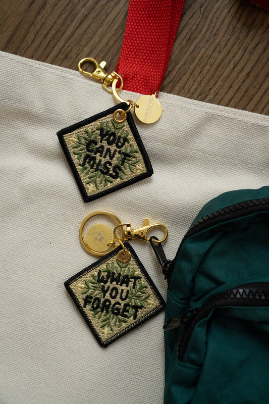 Never Meant Embroidered Keychain, close-up of stitching detail