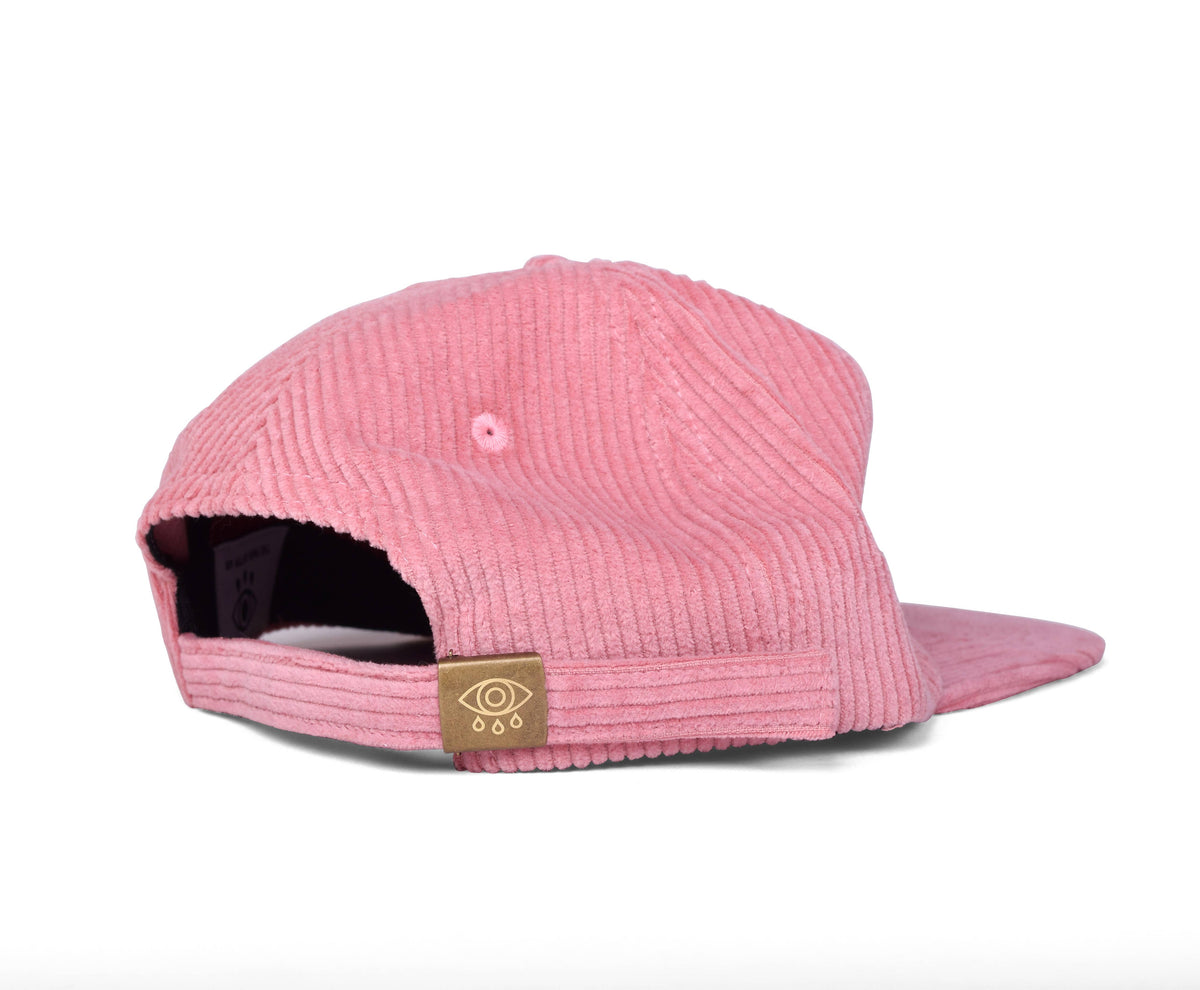 Pink corduroy Snake Lord dad hat displayed flat, showing the flat brim and stitched patch detail - PABOOM