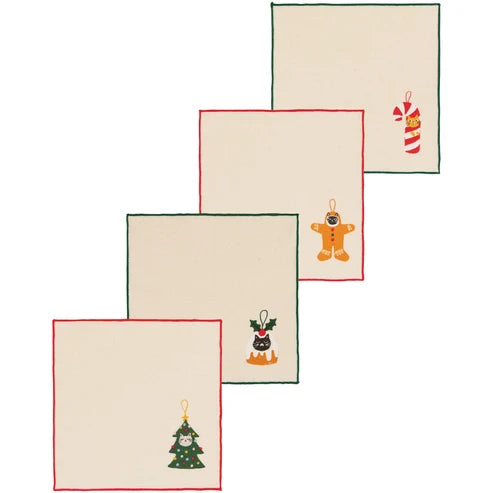 Four cream cocktail napkins with red and green borders, embroidered with whimsical holiday ornament motifs including a candy cane, gingerbread figure, and tree - PABOOM