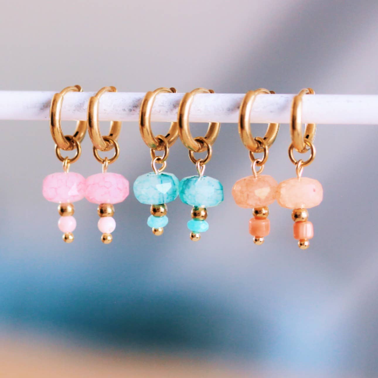Close-up of coral faceted stone hoop earring detail - PABOOM