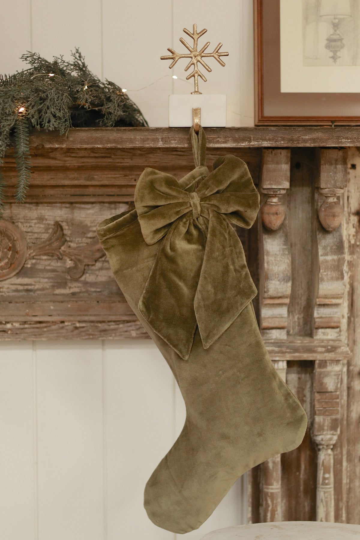 Vera Velvet Stocking in Olive styled with holiday greenery