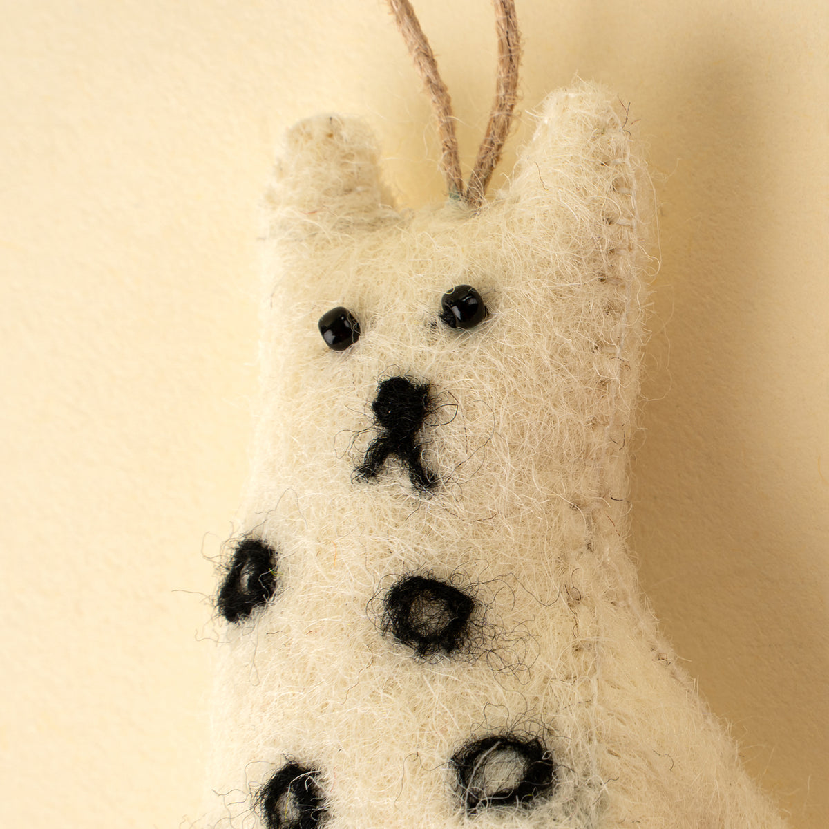 Curious Cat Felt Ornament, Spotted, hanging by its cord