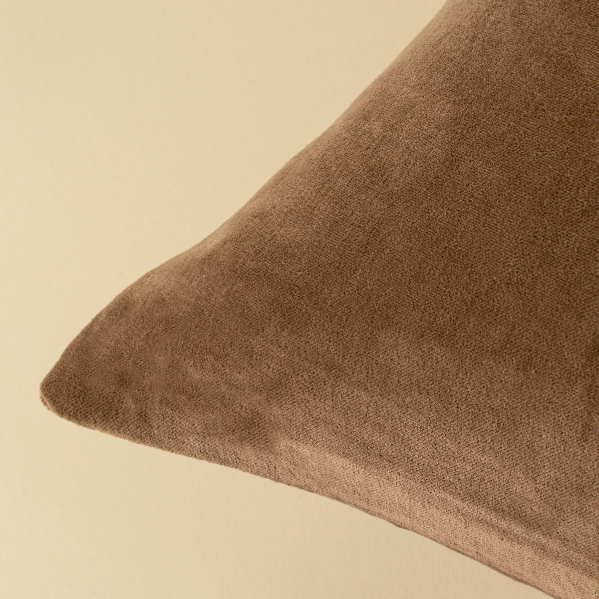 Close-up of the stonewashed velvet texture on the Vera Luxe Velvet Pillow in Caramel