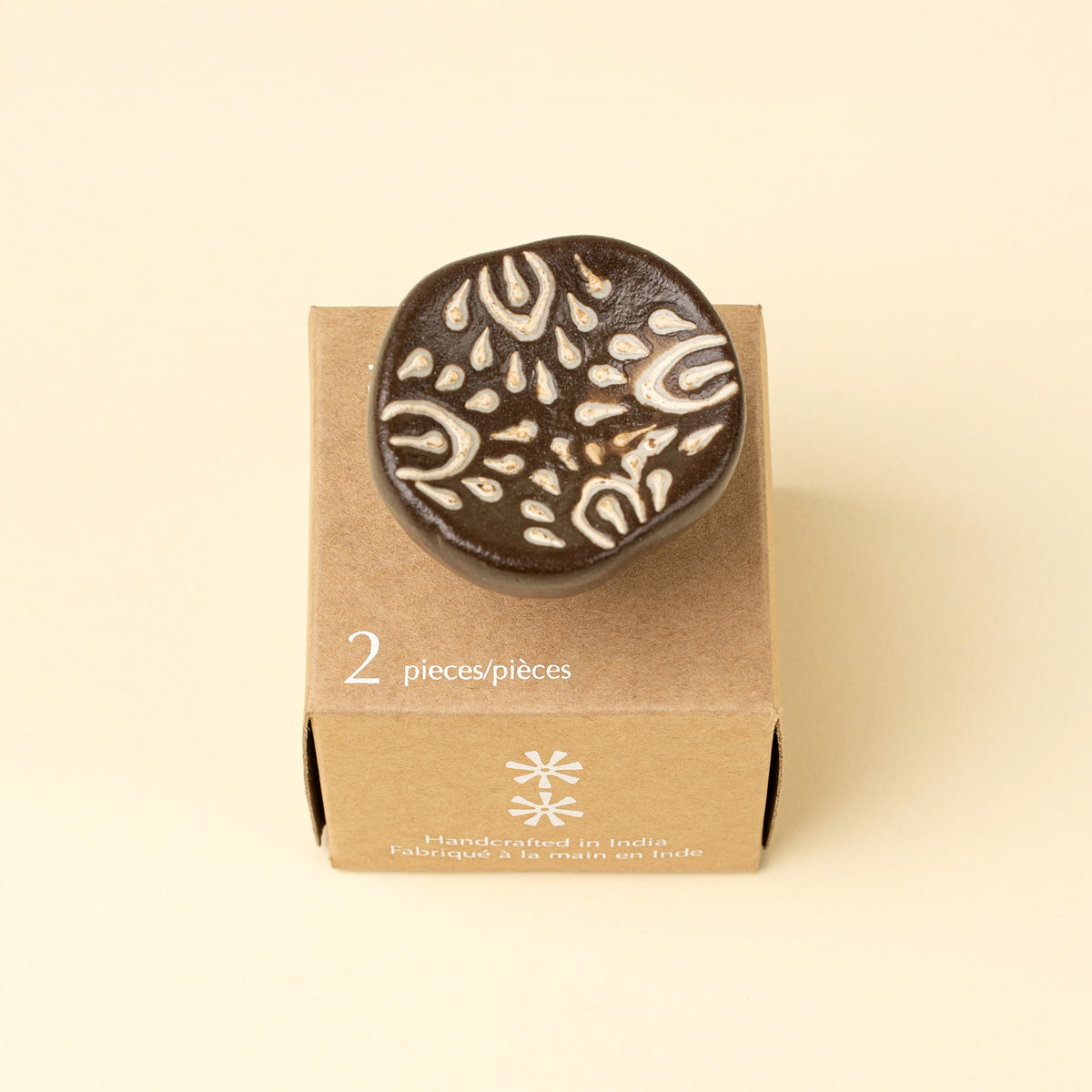 Earthen Ceramic Knobs in Brown shown installed on a drawer