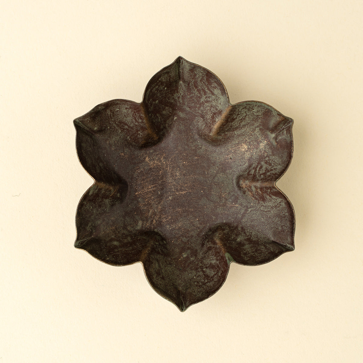 Close-up of the green patina finish on the Florentine Catchall Dish, Petal