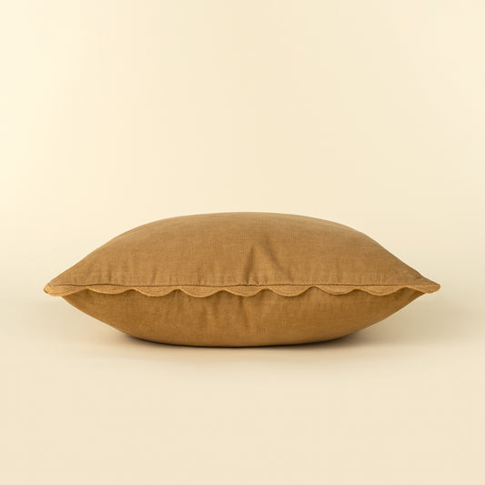 Corduroy Scallop Pillow in Gold styled on a sofa
