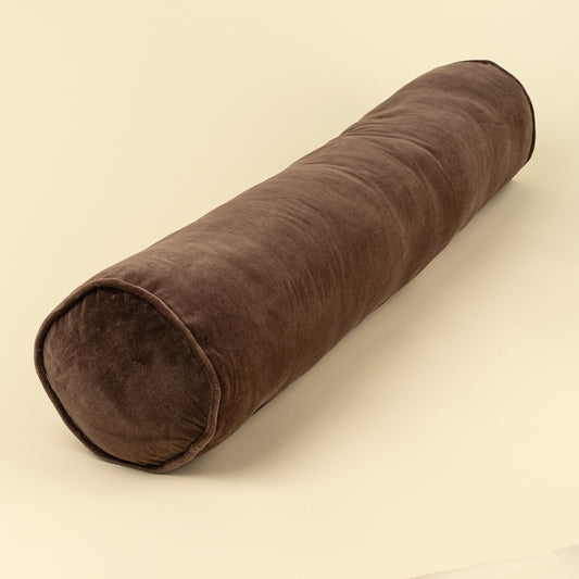 Vera Velvet Long Bolster in Clove shown from an angled view