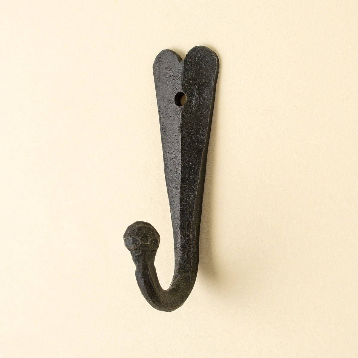 Black forged iron wall hook in a heart-inspired silhouette