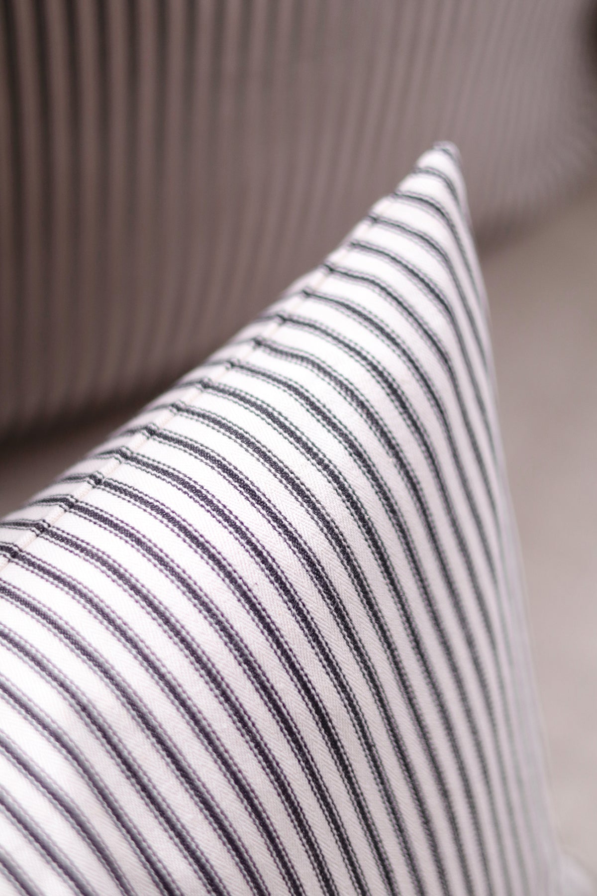 Black Ticking Pillow shown from a side angle