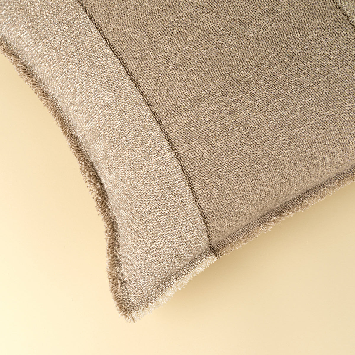 Close-up of the frayed edge detail on the Percy Pillow in Sand