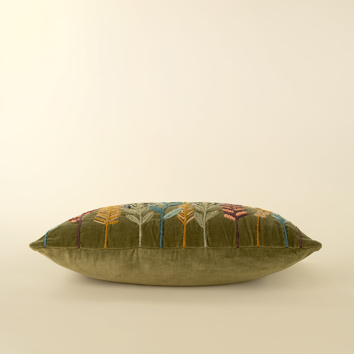 Close-up of the wool-stitched botanical embroidery on the Velvet Grove Pillow