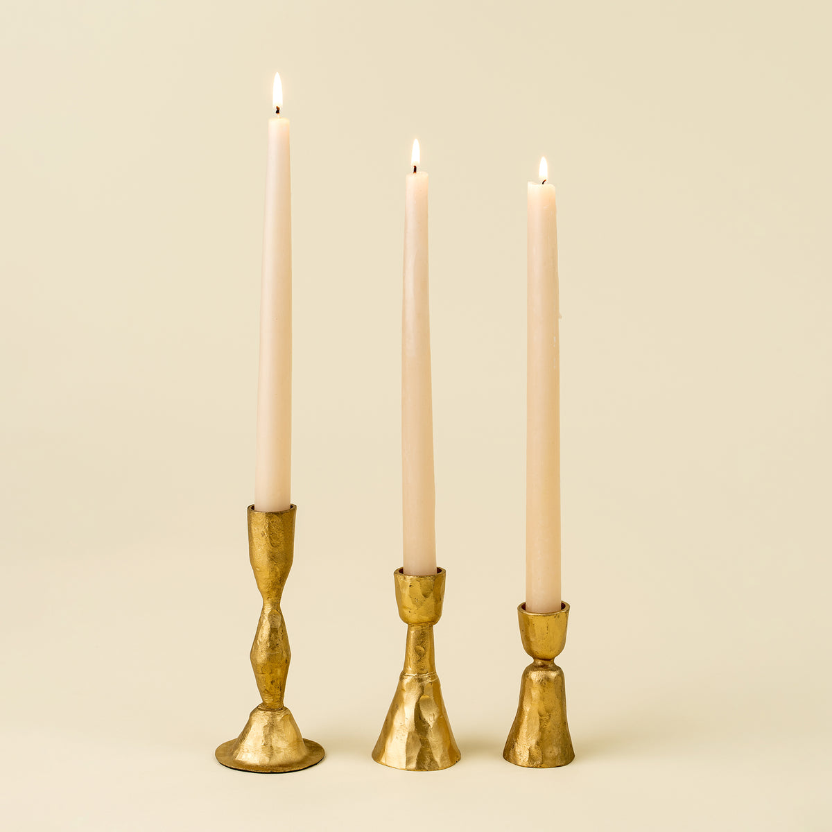 Close-up of the Zora Forged Candlestick's faceted gold stem and base