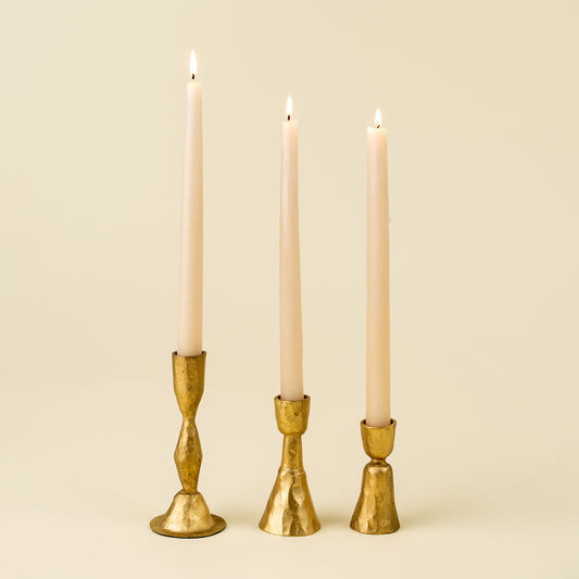 Close-up of the Zora Forged Candlestick's faceted gold stem and base