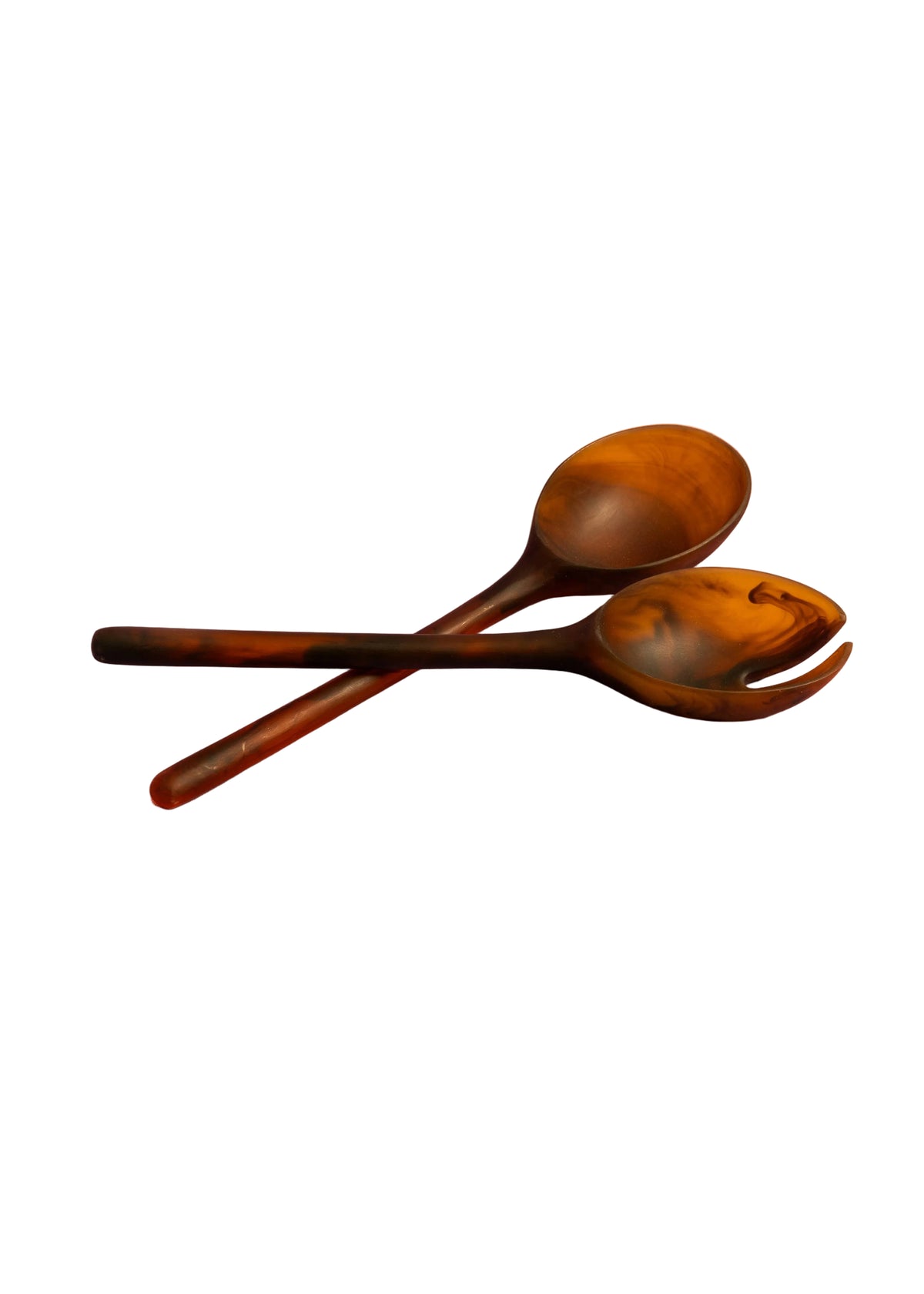 Marbled amber resin salad server fork and spoon crossed on a soft pink textured backdrop