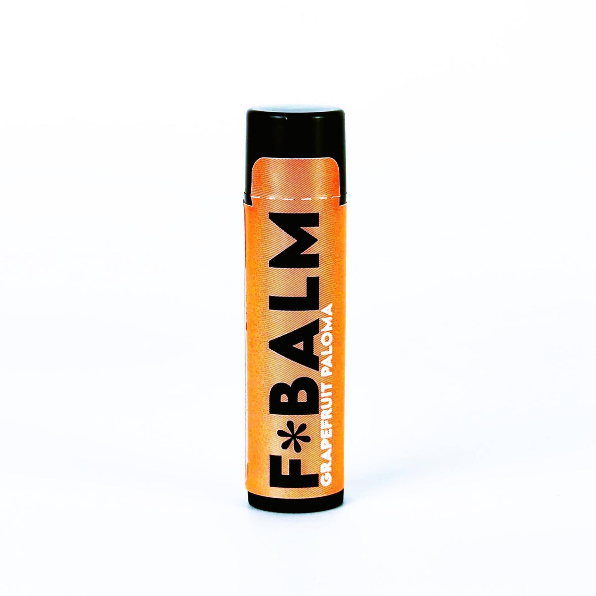 Charleston & Harlow F*Balm Grapefruit Paloma lip balm tube with orange kraft-paper label