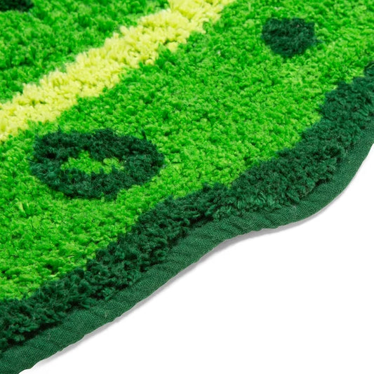 Pickle bath mat shown on a bathroom floor.