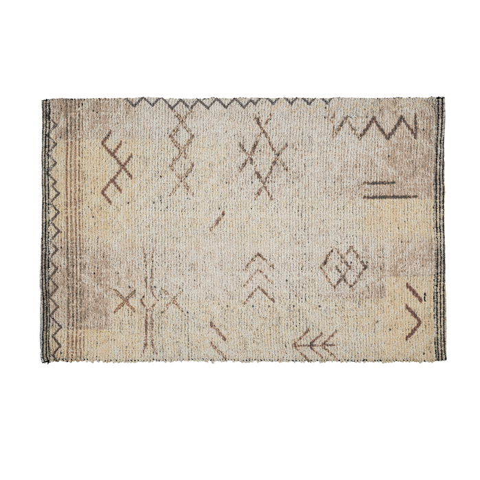 Cream cotton rug with rust and brown tribal-inspired geometric line patterns and a striped border