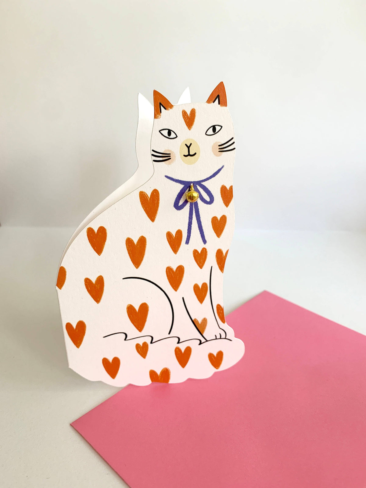 Sitting Kitty Shaped Greeting Card Loveheart shown at an angle highlighting the heart-print pattern