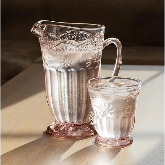 Retro pink glass pitcher and tumbler set on sunlit wooden table - PABOOM