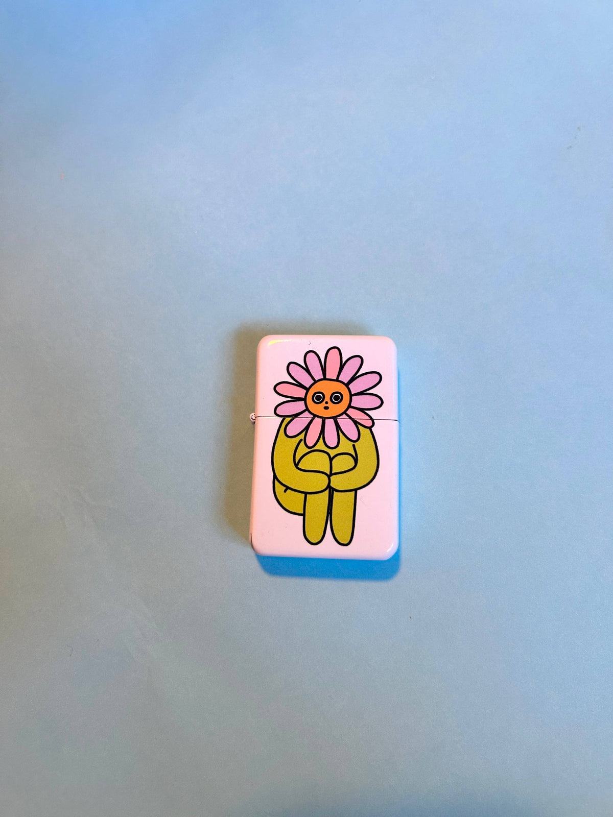 Flower Boy lighter styled in grass