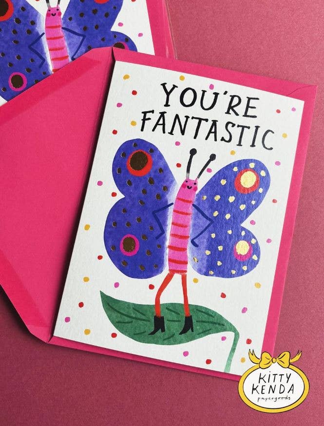 Kitty Kenda foiled greeting card with a gold-foil indigo butterfly illustration and "You're Fantastic" text