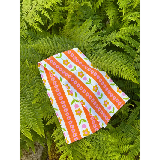 Tulip Stripes Cotton Tea Towel with hand-drawn floral pattern in bright colors – 100% cotton kitchen towel - against ferns - PABOOM