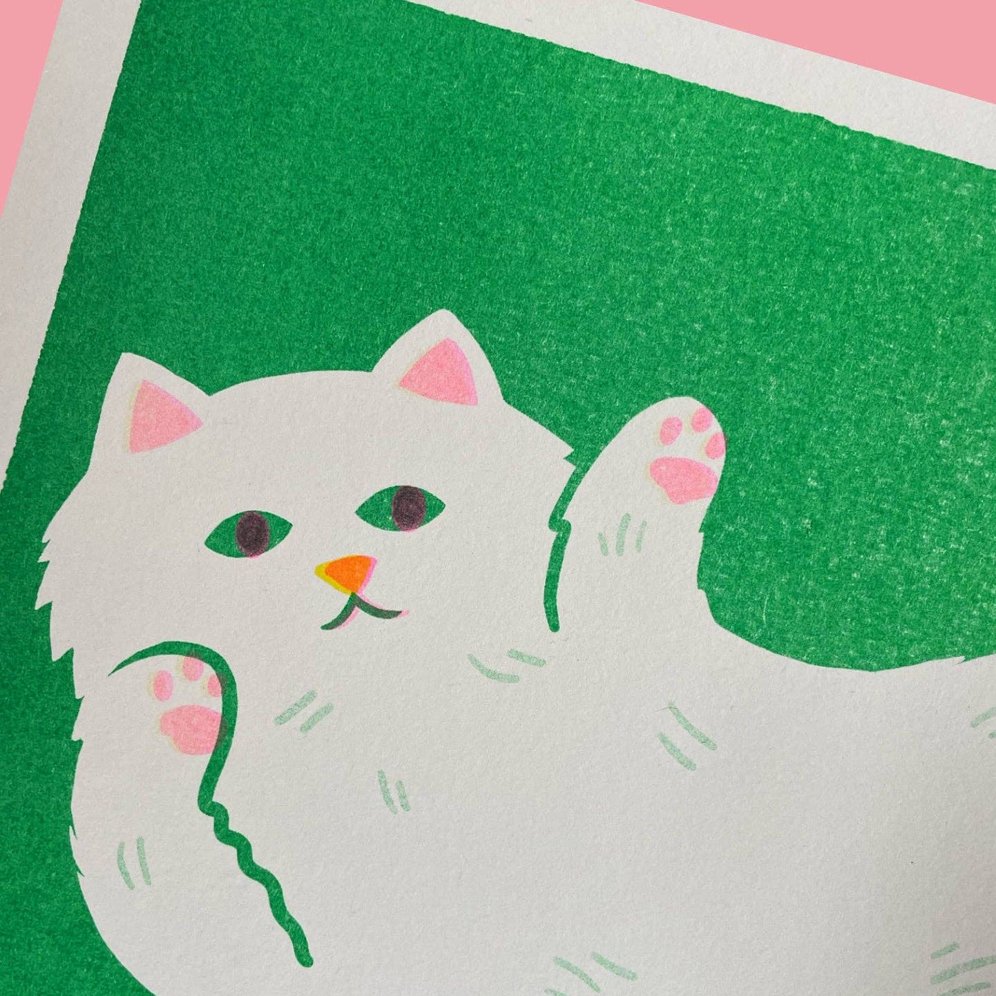 Stretching Cat risograph print shown unframed on a table - PABOOM