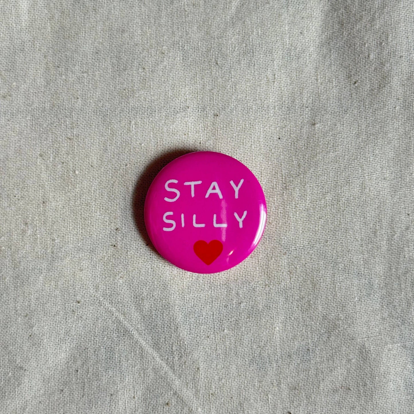 Green Stay Silly badge styled flat lay - PABOOM