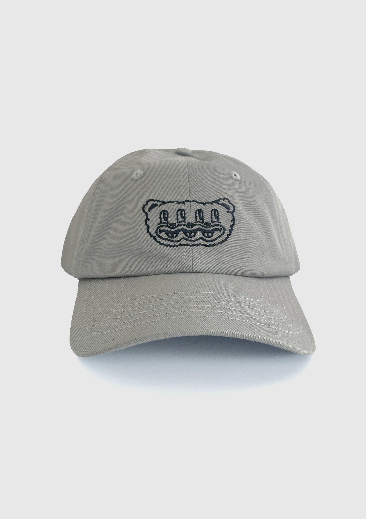 Grey dad hat with embroidered multi-eyed furry creature design on the front panel - PABOOM