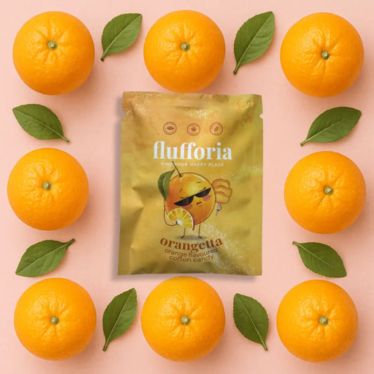 Package of Flufforia’s cotton candy, orangetta flavour, brown package, pink background with oranges - PABOOM