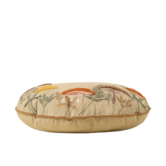 Decorative pillow with floral embroidery on a beige background