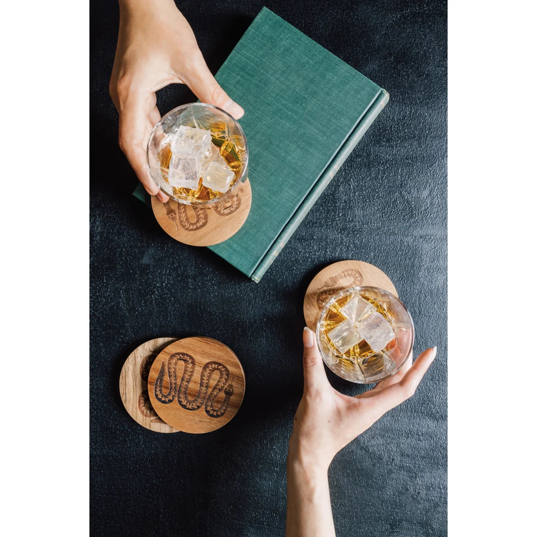 Close-up of the laser-engraved snake medallion on an Olympus acacia coaster - PABOOM