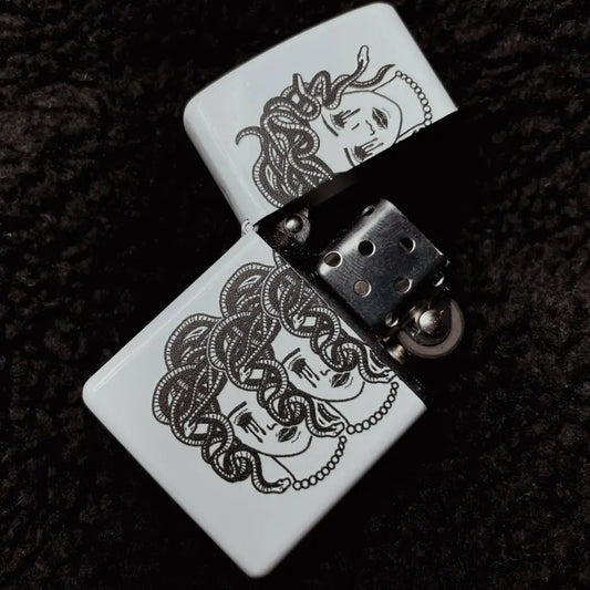 Zippo White lighter with 3 heads of medusa head with snakes and bleeding eyes, opened on black fabric