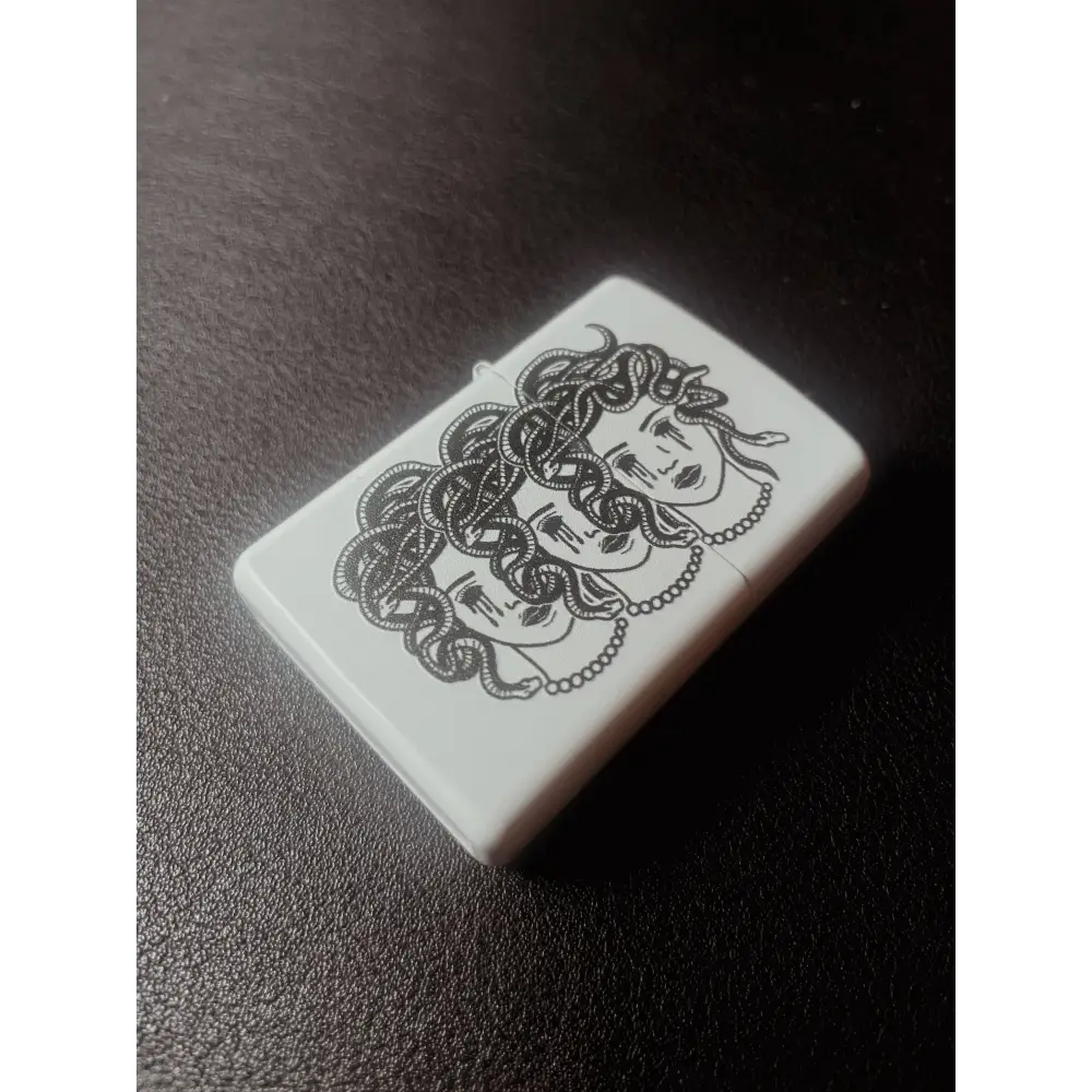 Zippo White lighter with 3 heads of medusa head with snakes and bleeding eyes, on black background