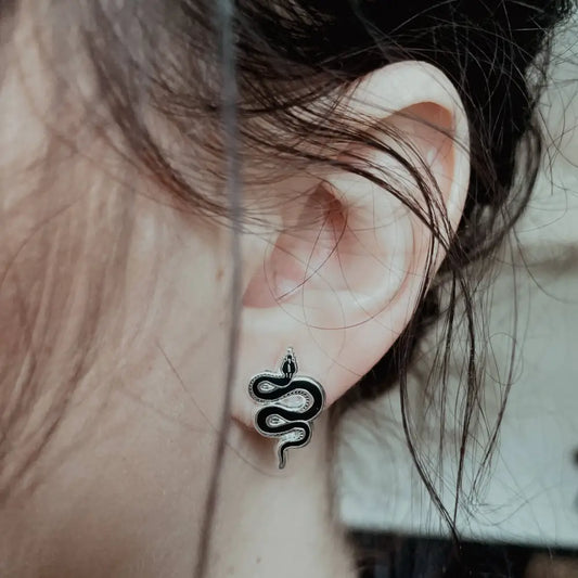 Tiny black and silver hard enamel snake earring stud on ear