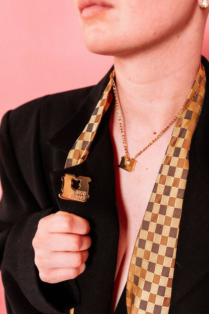 Bread Winner pin pinned onto fabric