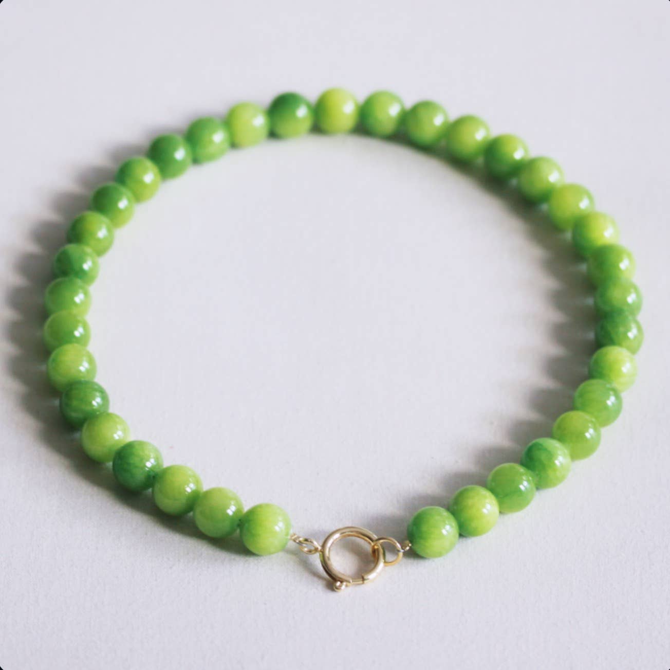 Chunky green natural stone bead necklace with a stainless steel spring-ring clasp, laid flat - PABOOM
