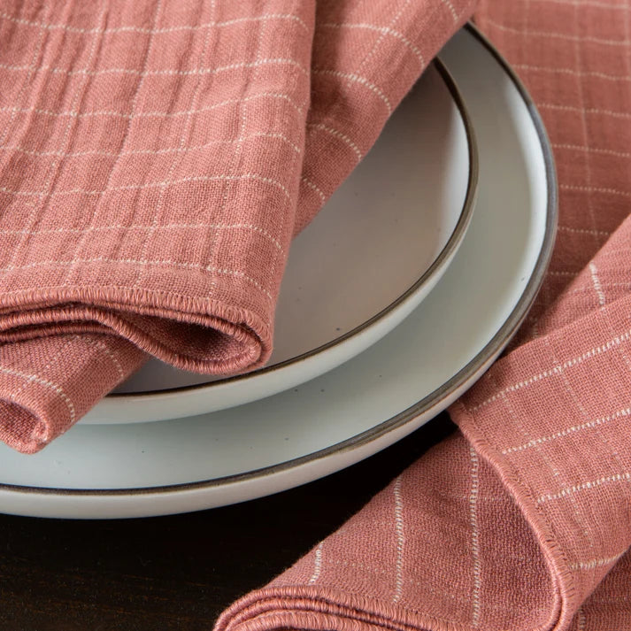 Stack of folded dusty rose cotton napkins with a soft double-weave texture – PABOOM