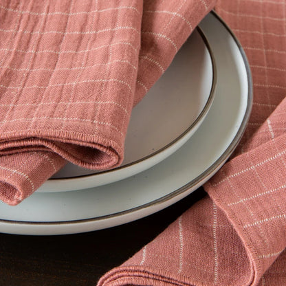 Stack of folded dusty rose cotton napkins with a soft double-weave texture – PABOOM