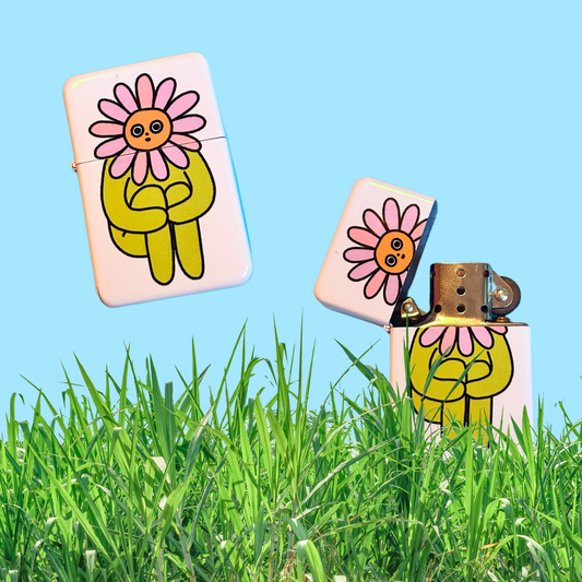 Pink metal lighter printed with an illustrated daisy-headed character