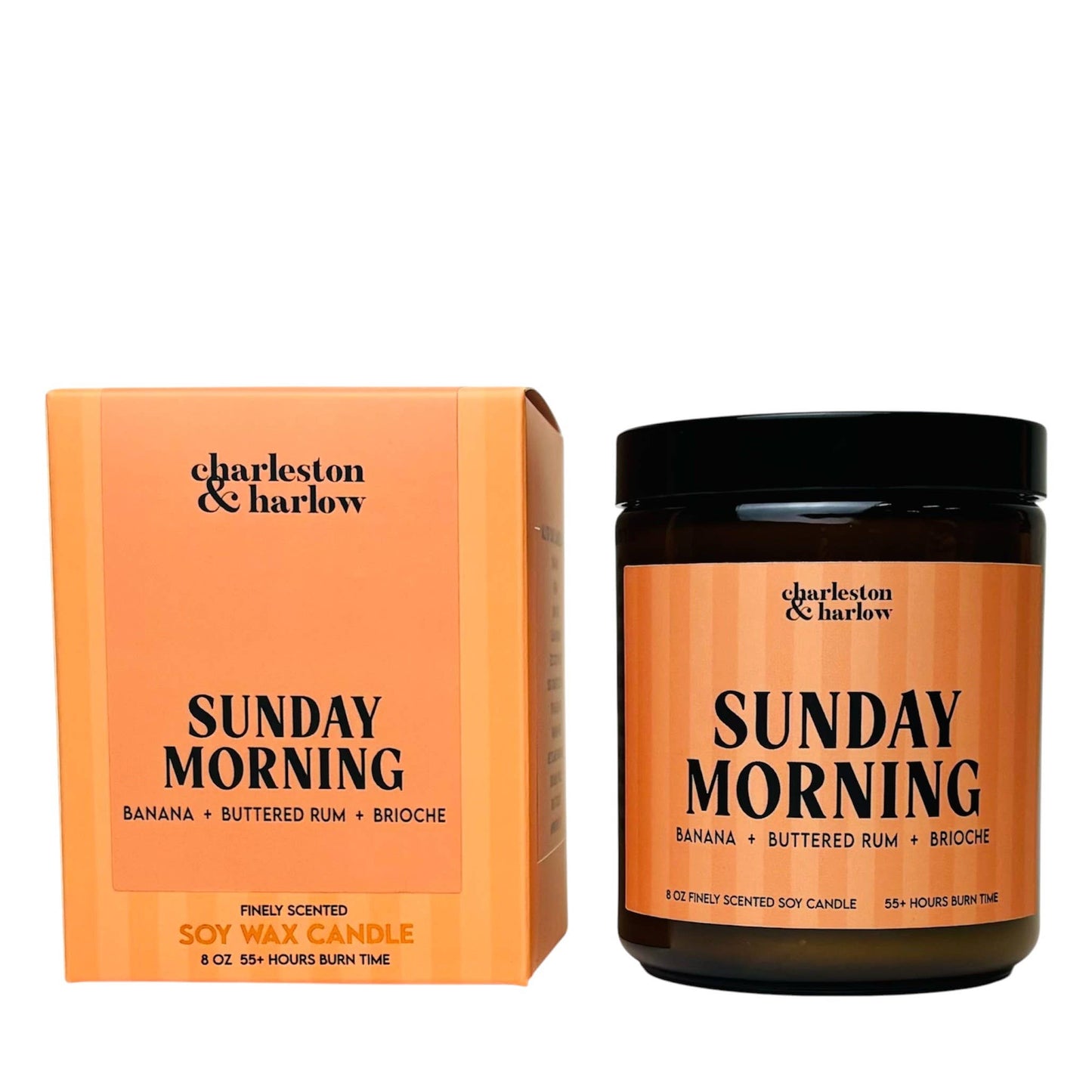 Charleston & Harlow Sunday Morning soy candle in amber glass jar with peach striped label, beside its matching gift box