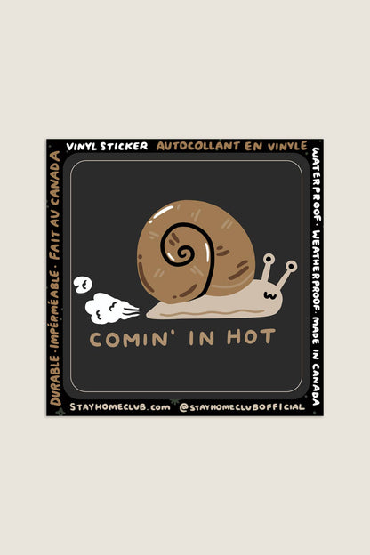 Black square vinyl sticker featuring an illustrated snail with a speed-trail motion effect and the text 'Comin' In Hot,' branded backing marked Made in Canada