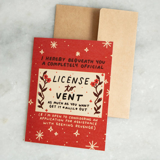 Red greeting card reading 'I Hereby Bequeath You a Completely Official License to Vent' with a punch-out wallet card, kraft envelope alongside