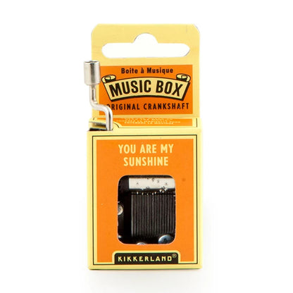 Yellow and orange 'You Are My Sunshine' crankshaft music box packaging with metal hand crank extended.