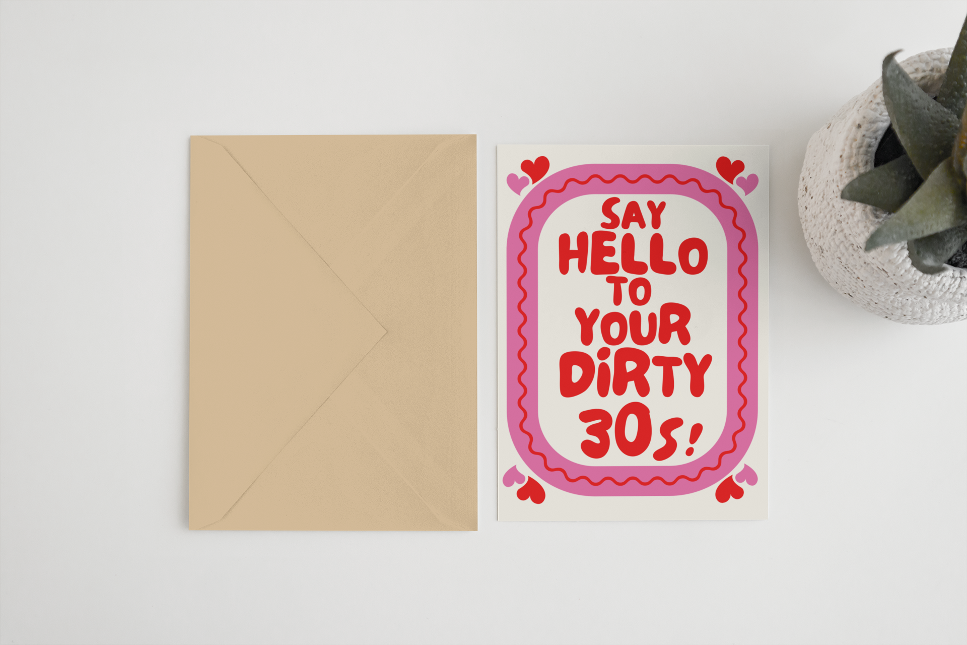 Blue Iris Designs Co 30th birthday card with pink scalloped border and red bubble text "Say hello to your dirty 30s!" beside a tan kraft envelope - PABOOM