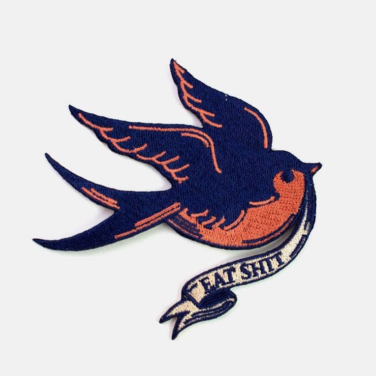 Iron-on embroidered patch of a swallow bird carrying a banner reading Eat Shit - PABOOM