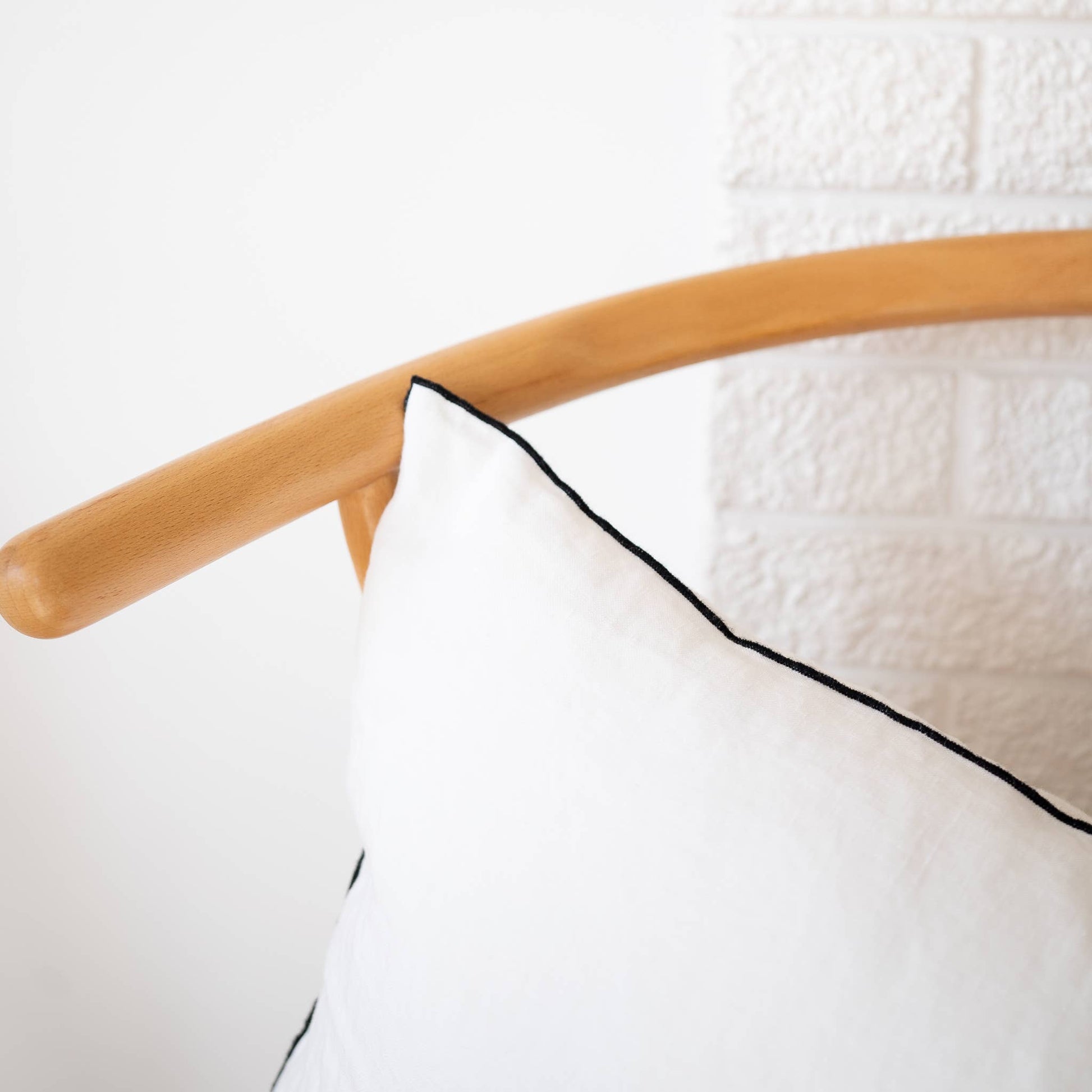 White edged linen lumbar pillow cover styled on a sofa
